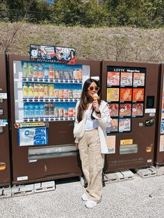 a woman standing in front of a vending machine