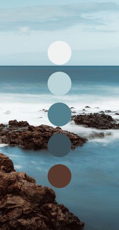 an image of the ocean and rocks with circles on it's surface in front of the water