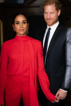 prince harry and his wife, the duke of cambridge pose for a photo in their red outfits