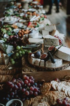 Wedding day grazing board with cheese, figs, crackers and grapes set on wooden boards across table Cheese And Cracker Table For Wedding, Food On Wooden Board, Wedding Charcuterie Board On Each Table, Graze Board Wedding, Large Wedding Charcuterie Table, Italian Grazing Table Ideas, Elegant Grazing Table Wedding, Moody Grazing Table, Winter Wedding Charcuterie Board