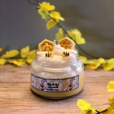 two waffles sticking out of the top of a jar filled with cream and honey