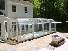 a white house with a pool in the backyard