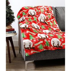 a couch with a christmas themed blanket on it