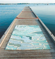 a blue rug is on the end of a pier