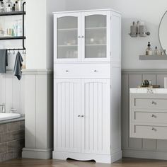 a white cabinet in a bathroom next to a sink