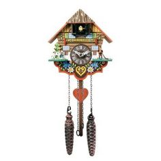 a cuckoo clock with pine cones hanging from it's sides