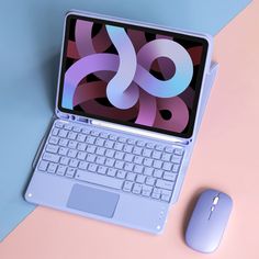 an open laptop computer sitting on top of a desk next to a mouse and keyboard