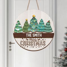 a wooden sign hanging on the front door of a house that says, the smith merry christmas