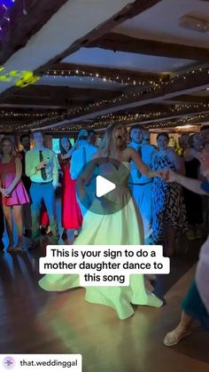 a group of people dancing on a dance floor with the words, this is your sign to do a mother daughter dance to this song