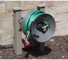 a garden hose is attached to the side of a building with a sprinkler