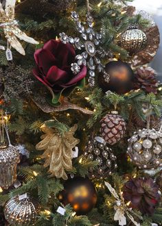 a christmas tree decorated with gold and red ornaments