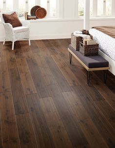 a bedroom with wood floors and white walls