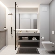 a bathroom with a toilet, sink, and shower stall in the middle of it