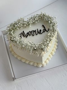 a heart shaped cake with the word married written on it