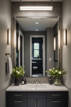 a bathroom with two sinks, mirrors and lights