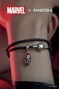 a person wearing a bracelet with a skull on it