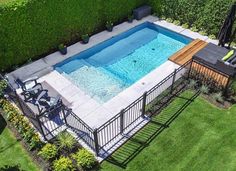 an aerial view of a backyard with a swimming pool