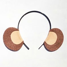 a pair of headphones that are made out of wood and leather with two circles on each side