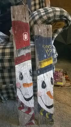 two wooden snowboards with faces painted on them