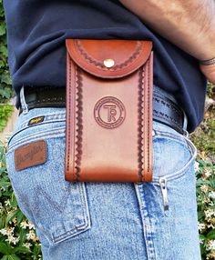 a man is wearing a leather belt case