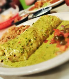 a white plate topped with meat covered in sauce