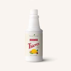 a bottle of thieves on a white background with an orange in the middle