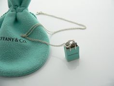 Here is a gift that she will surely adore! It is THE classic Tiffany piece - super pretty, stylish, and very versatile! This "Shopping Bag" will make someone REALLY happy! :) Offered for sale is a wonderful Tiffany & Co. Sterling Silver & Blue Enamel Shopping Bag charm necklace. Hanging from its gorgeous Tiffany curb chain is a super fabulous and super cool Tiffany "shopping bag" :) How much more perfect can this be!! :) I am 100% sure that this is one necklace that will be used a lot! Great con Small Elegant Travel Bag, Small Elegant Bag For Everyday Use, Elegant Small Bag For Everyday Use, Chic Blue Bag For Gift, Elegant Blue Gift Bag, Small Elegant Bag, Elegant Blue Bags For Gifts, Elegant Blue Bags As Gifts, Elegant Rectangular Necklace For Everyday Use