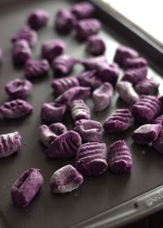 there are purple candy pieces on the baking sheet