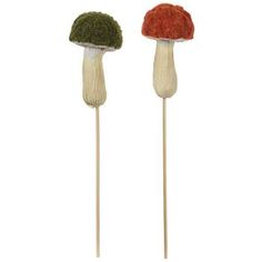 two mushrooms are sitting on top of toothpicks, one is green and the other is red