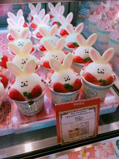 some cupcakes with bunny ears and strawberries in them