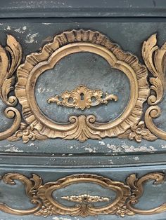 an ornate gold and blue painted dresser