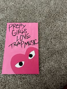 a pink sign with the words pretty girls love trap music written in black on it