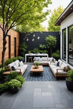 an outdoor living area with couches and tables