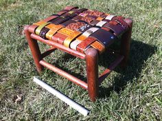 a stool made out of old leathers sitting in the grass