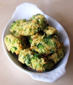 broccoli florets in a white bowl on a table