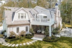 an aerial view of a large house in the middle of a wooded area with steps leading up to it