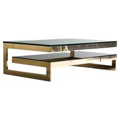 a modern coffee table with glass top and metal frame