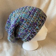 New! Slouchy Hat. Multi Color In Shades Of Blues, Greens, And Purples And A Little Golden Color. Nice Drape, Soft Yarn! Fit: Average Womens Brim Width: Approx 9 In X 10-1/4 Length Care: Machine Wash/Dry Cool/Warm 100% Acrylic Purple Bohemian Hats For Winter, Purple Bohemian Winter Hats, Bohemian Purple Winter Hat, Purple Beanie Hat, One Size, Purple One Size Beanie Hat, Handmade Purple Hat One Size, Purple Crochet Hat One Size Fits All, Purple Crochet Hat One Size, Bohemian Adjustable Purple Crochet Hat