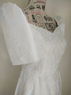 the back of a white wedding dress on display