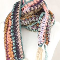 a multicolored crocheted scarf with tassels