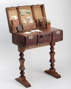 an old wooden desk with a clock and other items on it's top shelf