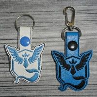 two key chains with different designs on them