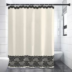 a white shower curtain with black lace on it