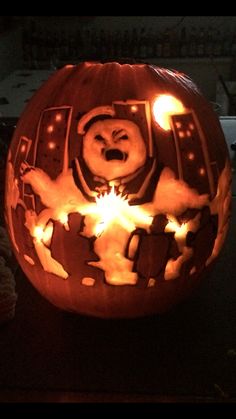 a carved pumpkin with an image of a bear in the center and some lights around it