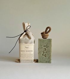 a soap bottle next to a rope wrapped bag