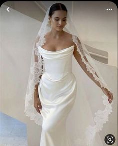 a woman wearing a wedding dress and veil