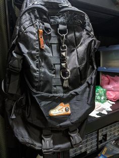 a black backpack sitting on top of a shelf