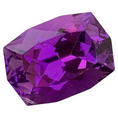 Faceted Amethyst Weight: 7.85 Carats Origin: Brazil Shape: Long Cushion Color: Purple Certficate: On Customer Demand . Amethyst is a captivating gemstone renowned for its striking purple hues and rich history. This violet to purple variety of quartz has captivated human imagination for centuries, with its name originating from the Greek word "amethystos," which means "not drunk." The ancient Greeks believed that wearing amethyst jewelry or drinking from amethyst cups would protect them from intoxication. Amethyst's alluring color ranges from pale lilac to deep violet, often displaying bands of varying shades. This gemstone's vivid coloration is attributed to the presence of iron and aluminum impurities within the crystal lattice. The finest amethysts exhibit a deep, royal purple hue, makin Luxury Unique Purple Gemstone, Prisma Hexagonal, Oval Purple Amethyst Gemstones, Round Faceted Purple Gemstones, Luxury Purple Amethyst Gemstones, Elegant Large Amethyst Gemstones, Crystal Lattice, Long Cushion, Purple Amethyst Ring