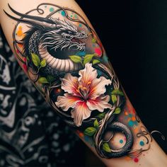 a dragon and flower tattoo on the arm