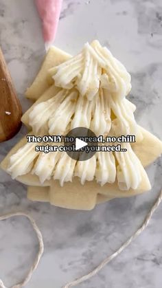 some kind of food sitting on top of a marble table next to a wooden spoon